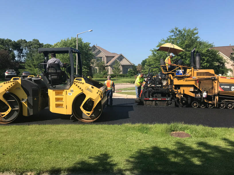 The asphalt paving crew of Geske & Sons working in Crystal Lake paving a new road
